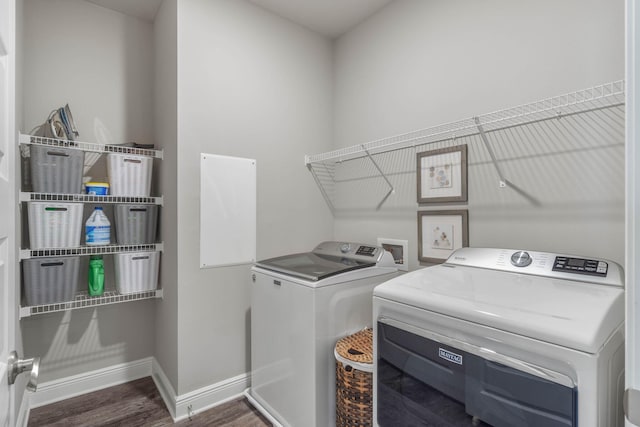 laundry area featuring dark hardwood / wood-style floors and washer and dryer