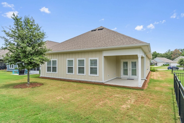 rear view of property with a patio area and a yard