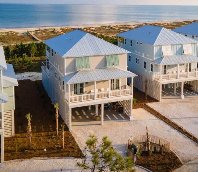 view of front of home featuring a balcony, a carport, and a water view