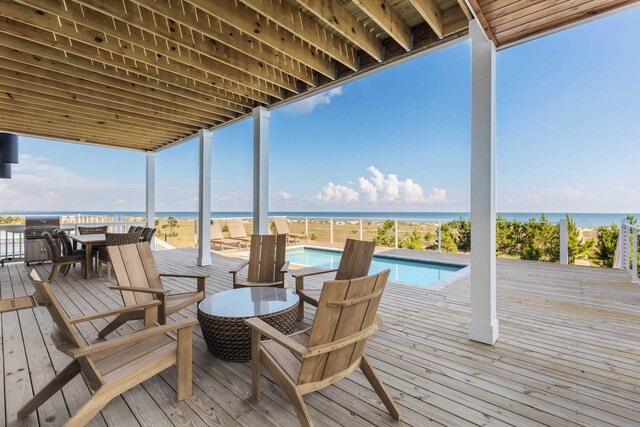 wooden terrace featuring a water view