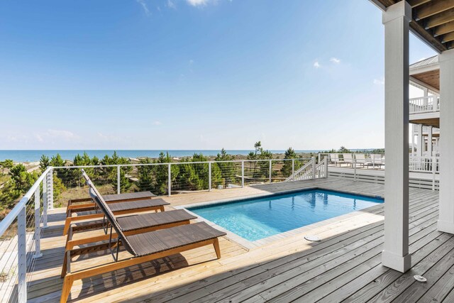 view of swimming pool with a deck with water view