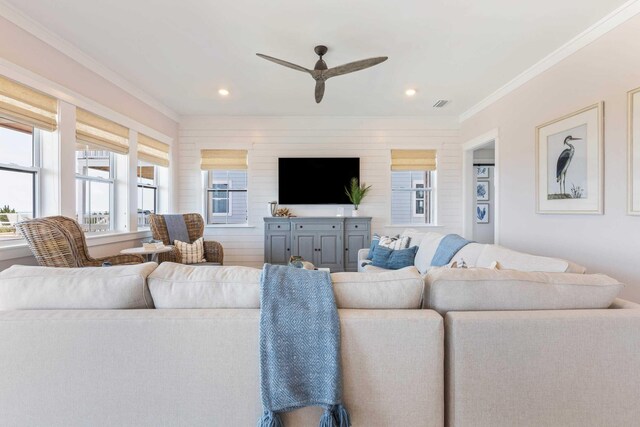 living room with crown molding and ceiling fan