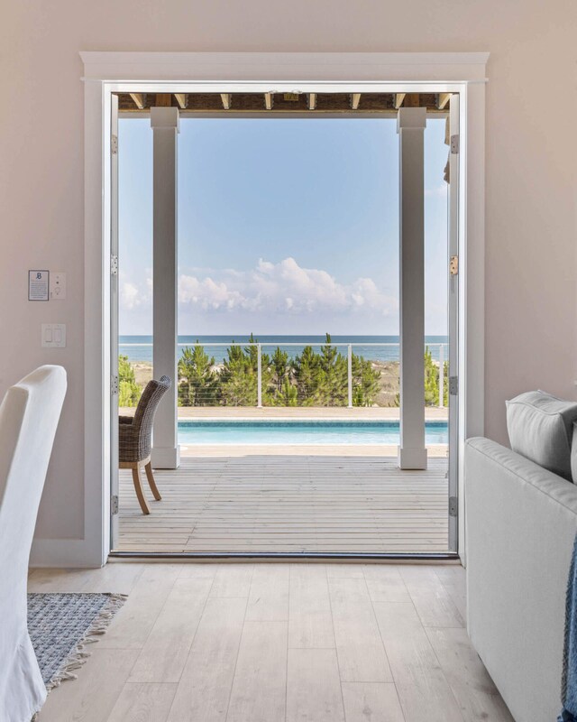 entryway with a water view and light hardwood / wood-style floors