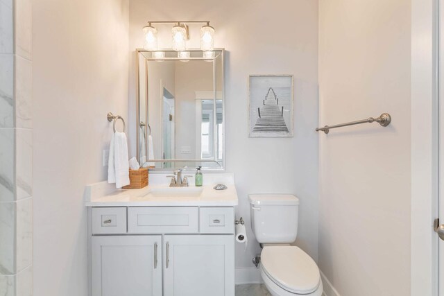 bathroom featuring toilet and vanity