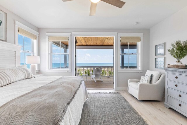 bedroom with ceiling fan, access to exterior, multiple windows, and light hardwood / wood-style flooring