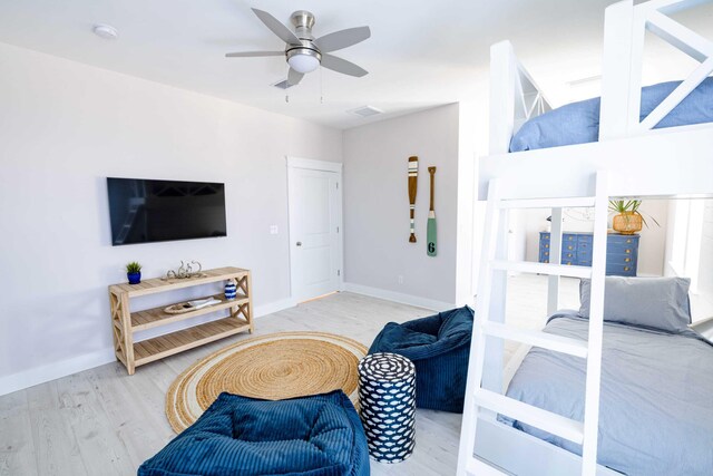 living room with ceiling fan and light hardwood / wood-style flooring