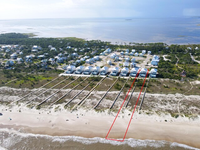 drone / aerial view featuring a view of the beach and a water view