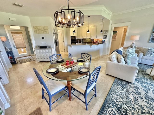 dining area with an inviting chandelier and crown molding