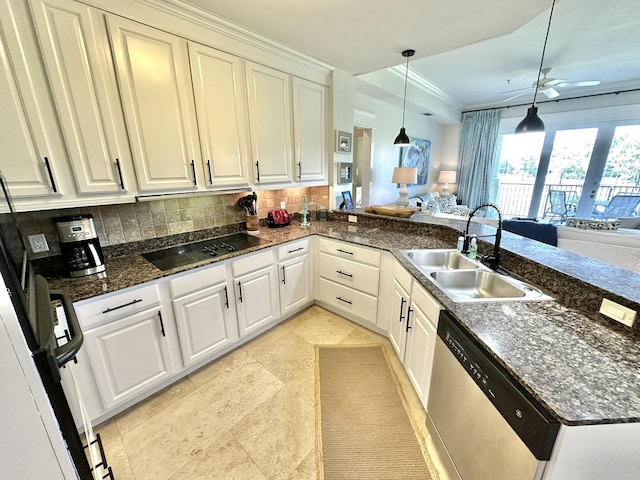 kitchen featuring backsplash, stainless steel dishwasher, sink, white cabinets, and hanging light fixtures