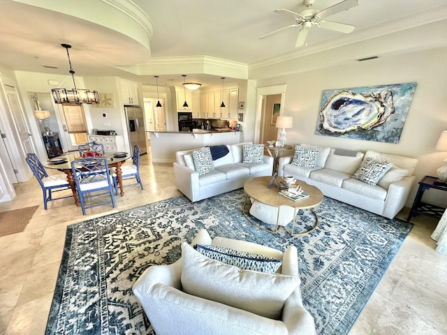 living room featuring ceiling fan with notable chandelier