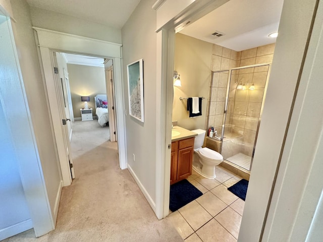 bathroom featuring tile patterned flooring, vanity, toilet, and walk in shower