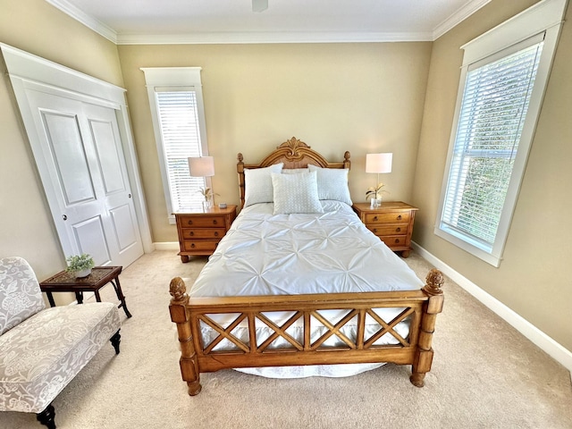 carpeted bedroom with ornamental molding and a closet