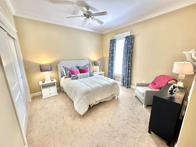 bedroom featuring ceiling fan, a closet, light colored carpet, and ornamental molding