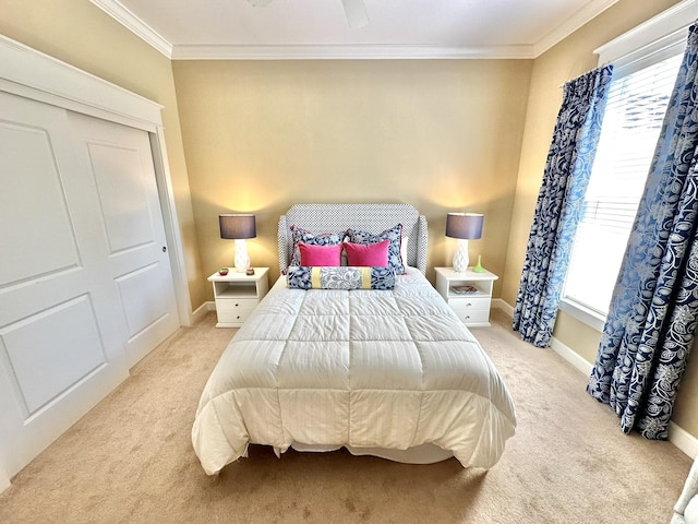 carpeted bedroom with multiple windows, a closet, and ornamental molding