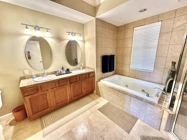 bathroom with vanity, tile patterned floors, and tiled tub