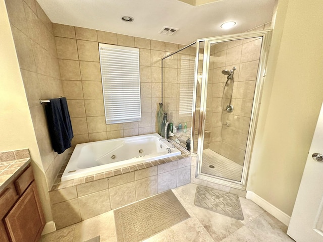 bathroom featuring tile patterned floors, vanity, and shower with separate bathtub