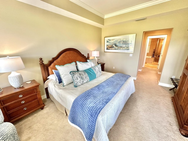 carpeted bedroom with ensuite bath and ornamental molding