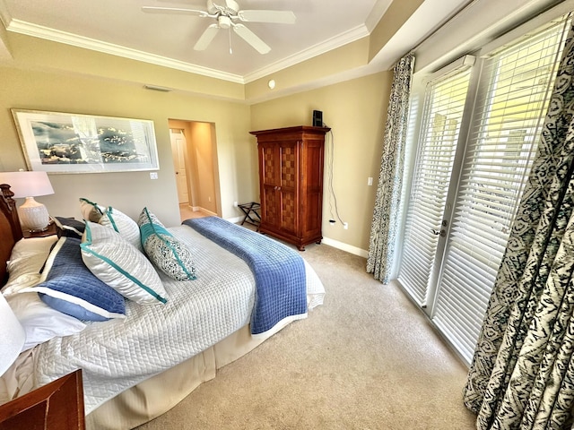 carpeted bedroom featuring a raised ceiling, access to exterior, ceiling fan, and ornamental molding