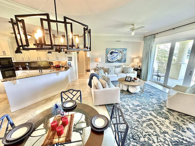 living room with ceiling fan, french doors, and ornamental molding