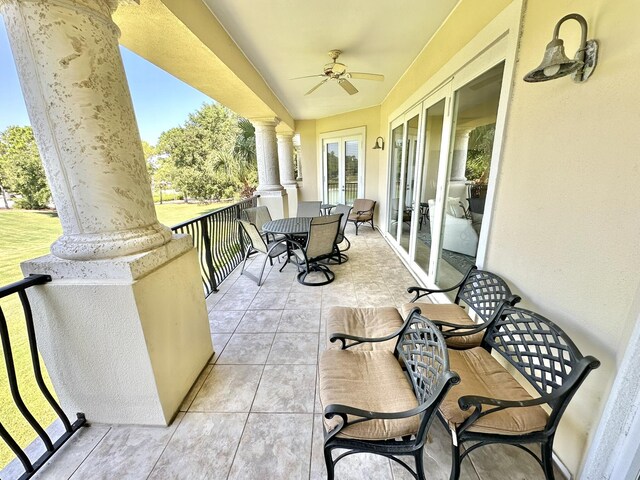 balcony with ceiling fan and french doors