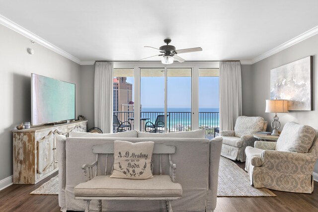 living room featuring ceiling fan, a healthy amount of sunlight, a water view, and dark wood-type flooring