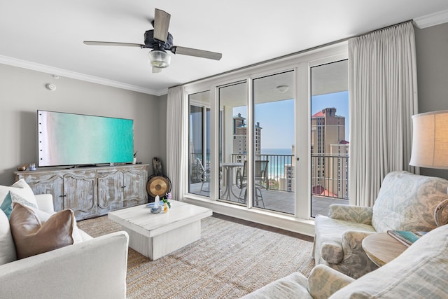 living room featuring hardwood / wood-style floors, ceiling fan, and crown molding