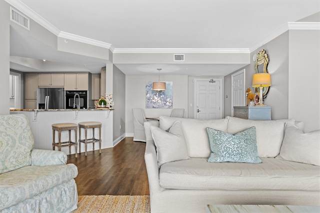 living room featuring dark hardwood / wood-style flooring and ornamental molding