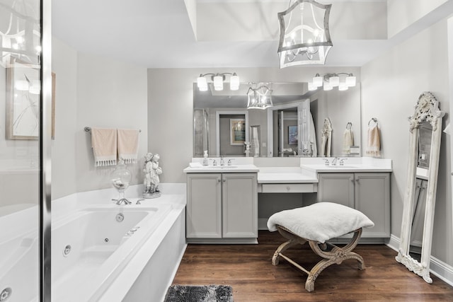 bathroom with hardwood / wood-style floors, vanity, and a bathing tub