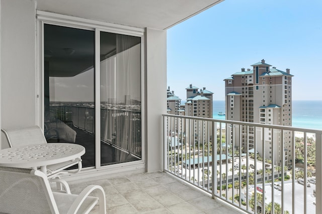 balcony featuring a water view and a beach view