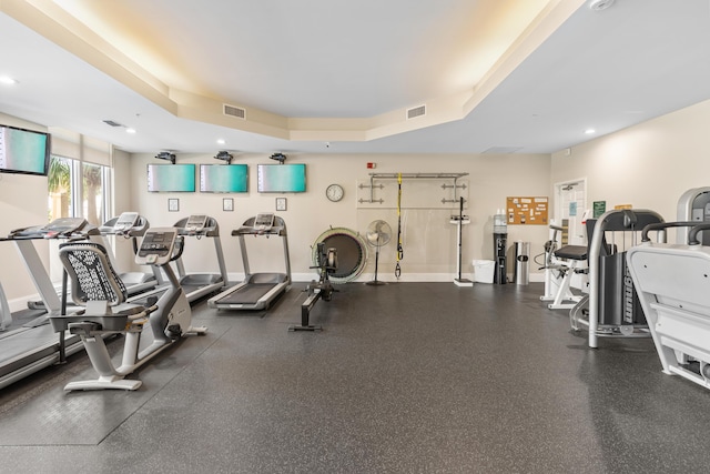 workout area with a raised ceiling