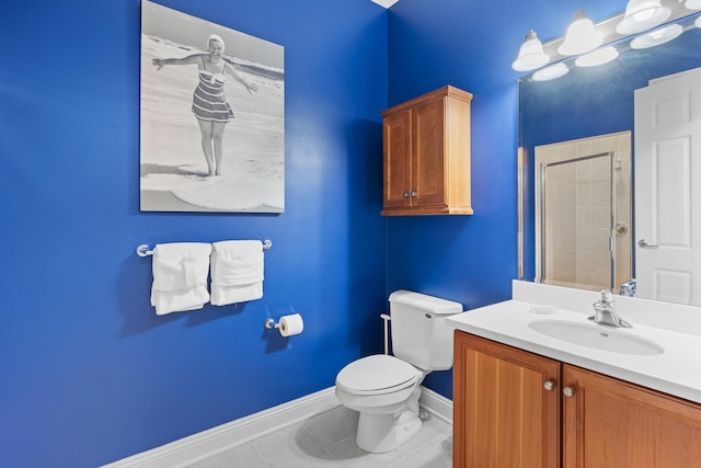 bathroom with tile patterned floors, vanity, tiled shower, and toilet