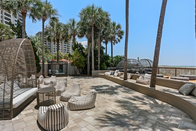 view of patio with an outdoor living space with a fireplace