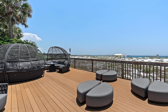 wooden terrace with a water view and a beach view