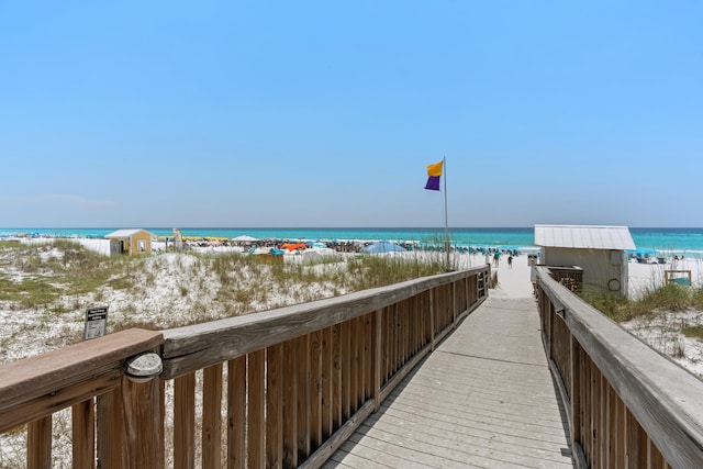 view of home's community with a water view and a view of the beach