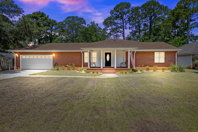 single story home with a garage and a yard