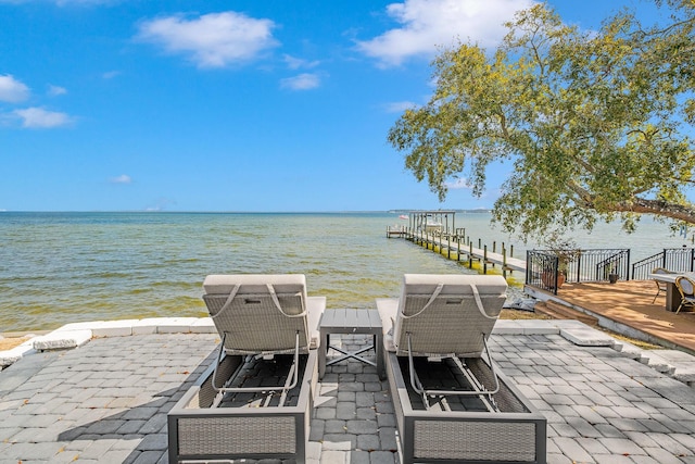 view of patio / terrace featuring a boat dock and a water view