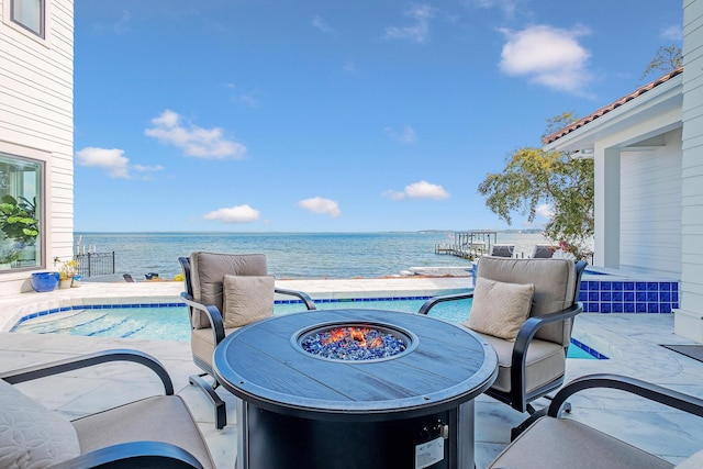 view of patio / terrace featuring a water view and an outdoor fire pit