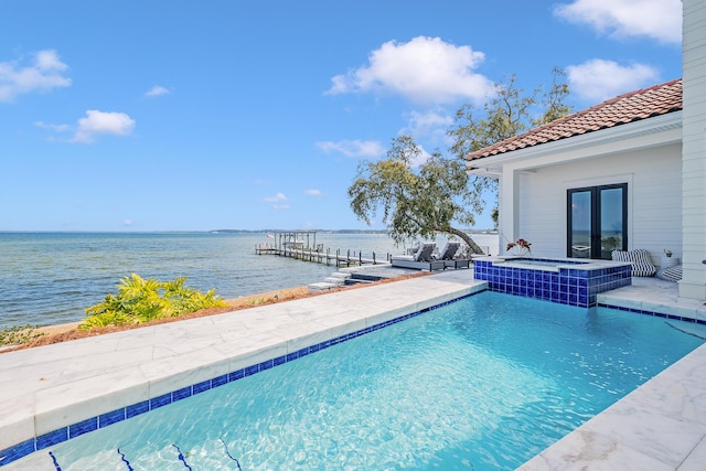 view of pool featuring an in ground hot tub, a boat dock, a water view, and french doors