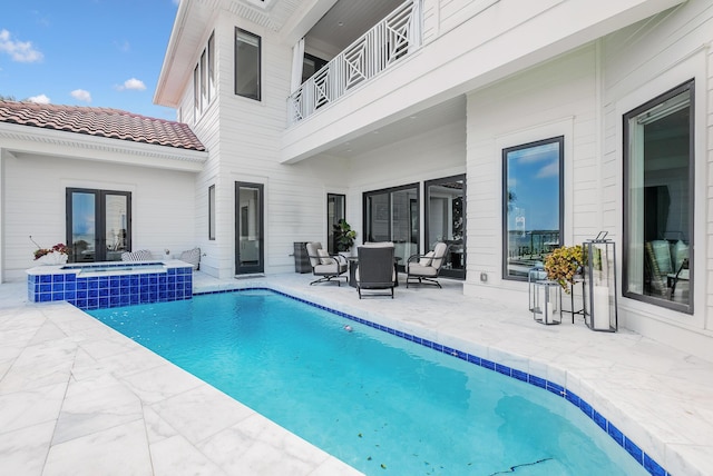 view of pool featuring an in ground hot tub, french doors, and a patio