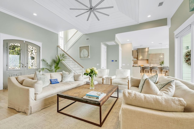 living room with ceiling fan, light wood-type flooring, wood ceiling, and french doors