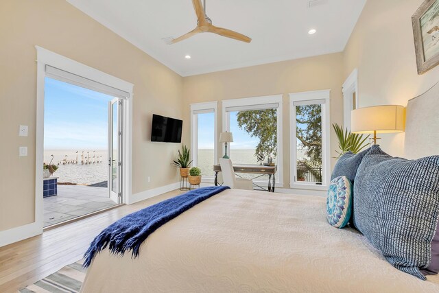 bedroom with access to outside, multiple windows, ceiling fan, and wood-type flooring