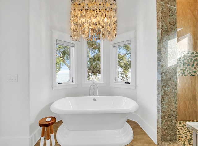 bathroom featuring a bath and an inviting chandelier