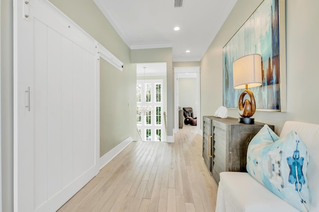 hall featuring light hardwood / wood-style floors and ornamental molding