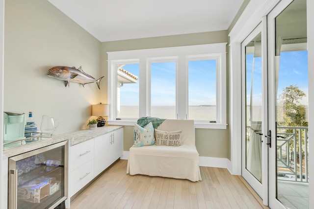 sitting room featuring light hardwood / wood-style floors and beverage cooler