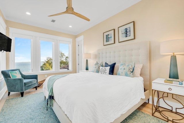 bedroom with light wood-type flooring and ceiling fan