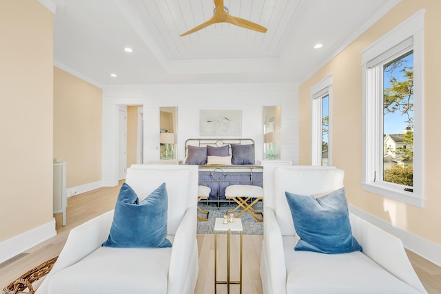 bedroom featuring light hardwood / wood-style flooring, a raised ceiling, ceiling fan, and wooden ceiling