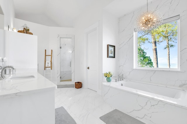 bathroom with plus walk in shower, vanity, a chandelier, and a wealth of natural light