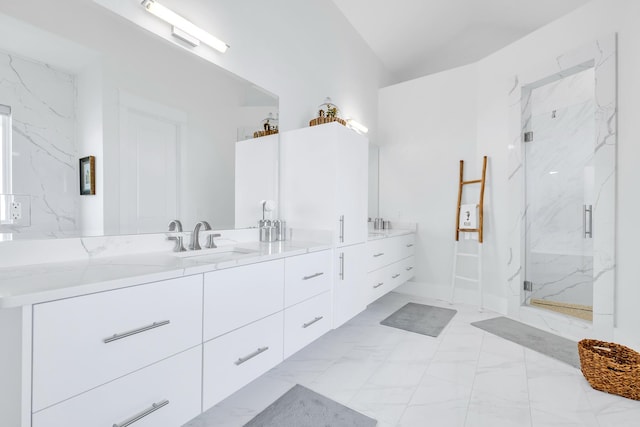 bathroom with vanity, lofted ceiling, and walk in shower