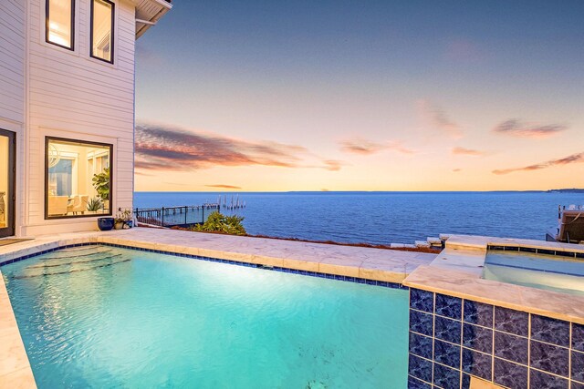 pool at dusk with a water view