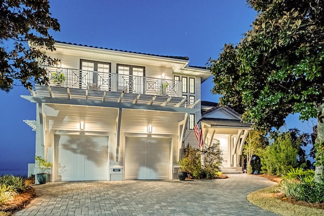 view of front facade with a garage and a balcony